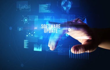 Hand touching SOFTWARE UPDATE inscription, new business technology concept